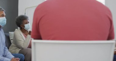 Yüz maskeli bir grup kıdemli arkadaş destek toplantısı yapıyorlar. üst düzey sağlık, destek ve yaşam tarzı.