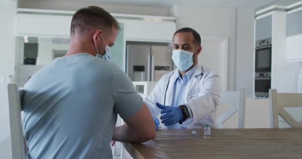 Mixed Race Male Doctor Wearing Face Mask Giving Vaccine Male — Stock Video