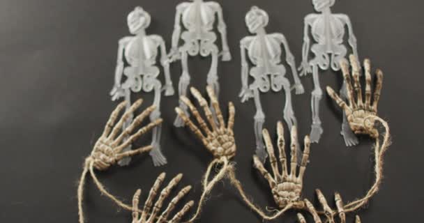 Multiple Skeleton Toys Skeleton Hands Copy Space Grey Background Halloween — Stock Video