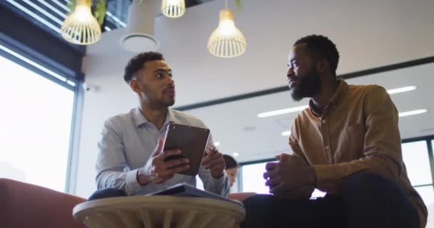 Video Two Diverse Businessmen Talking Using Tablet Lounge Area Busy — Stock Video