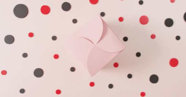 Overhead View Pink Gift Box White Background Red Black Dots — Stockvideo