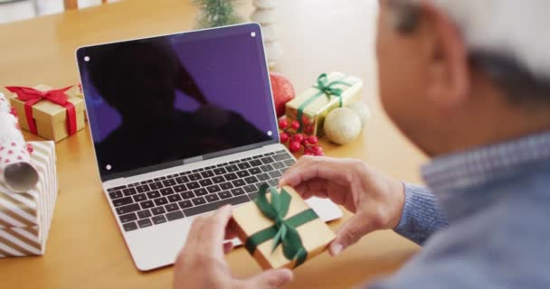 Video Senior Biracial Man Holding Gift Making Christmas Laptop Video — Stock Video