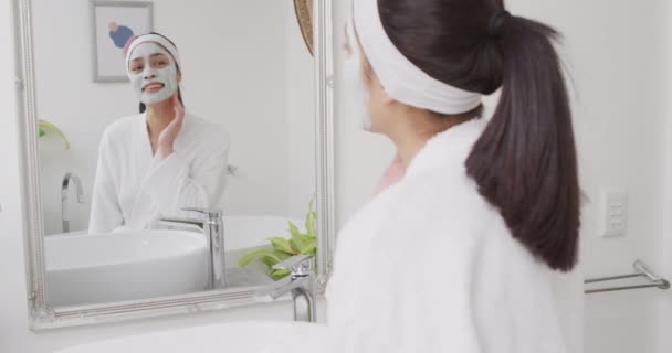Biracial Γυναίκα Εφαρμογή Κρέμα Στο Πρόσωπο Στο Μπάνιο Ομορφιά Υγεία — Αρχείο Βίντεο