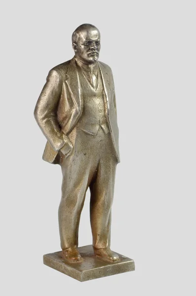 Kleine oude nikkel zilver standbeeld van lenin, op een grijze achtergrond — Stockfoto