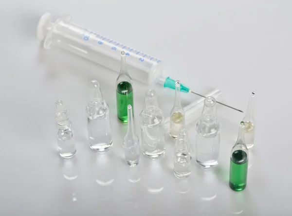 Table with medical ampoules — Stock Photo, Image