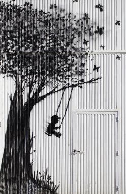 Child swinging in tree clipart