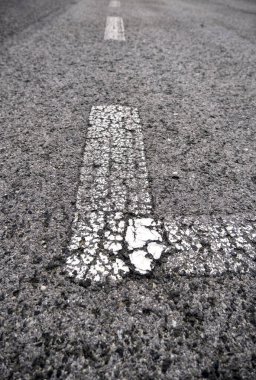 Marking lines on the asphalt, information sign