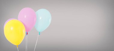 holiday helium balloons isolated on grey background, birthday concept