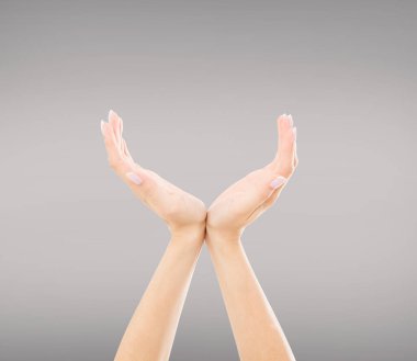 Hands holding something invisible, isolated on grey background