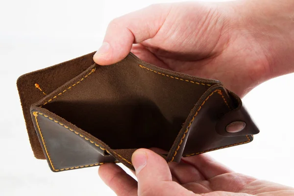 Empty wallet in hands. On a white background isolated - Bankruptcy