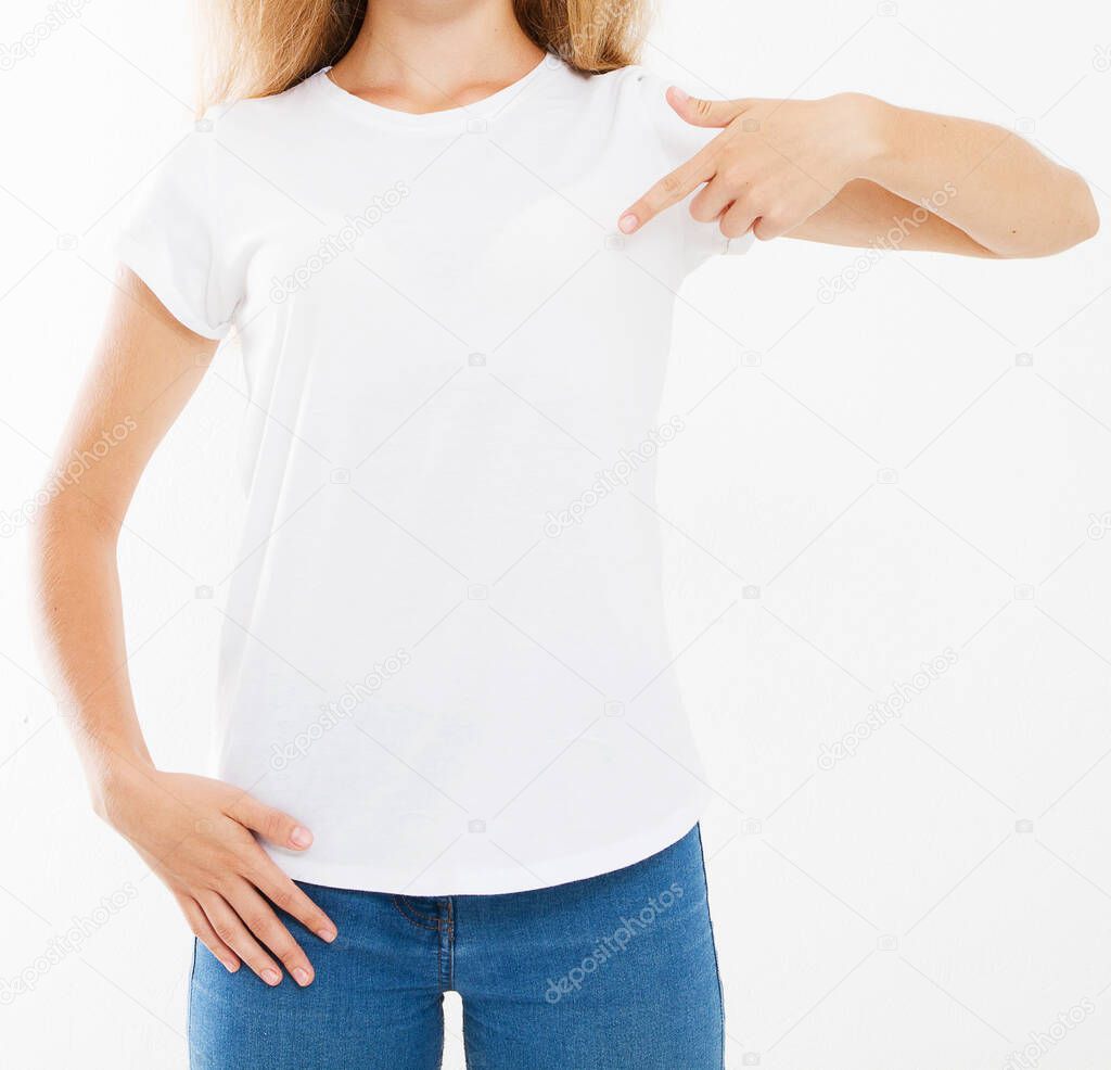 Attractive caucasian woman pointing with fingers to her blank white t-shirt isolated on white background