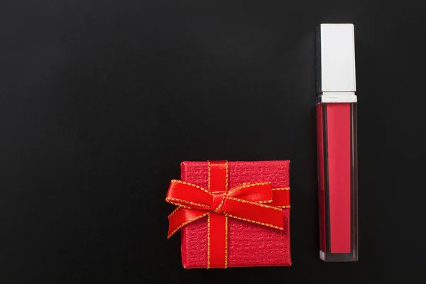 Cosmetics on black background and gift boxes. Top view and mock up. Copy space. Valentines day