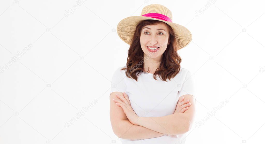 Happy beautiful middle age woman in summer hat isolated on white background. Summertime head and face skin care protection. Hot season and trendy women accessories. Template blank t shirt. Copy space.