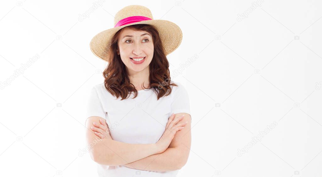 Happy beautiful middle age woman in summer hat isolated on white background. Summertime head and face skin care protection. Hot season and trendy women accessories. Template blank t shirt. Copy space.