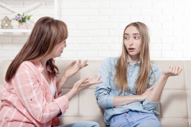 Erken hamilelik. Anne ve kızı arka planda kanepede oturuyorlar. Boşluğu kopyala ve modelle