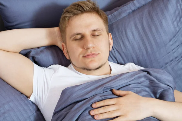 Portrait cute young man sleeping on bed bedroom