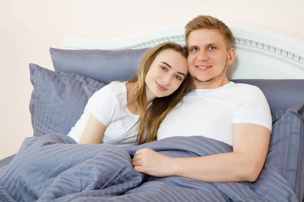 happy couple in love on morning bed, Young loving couple in the bed, Young couple having having romantic times in bedroom