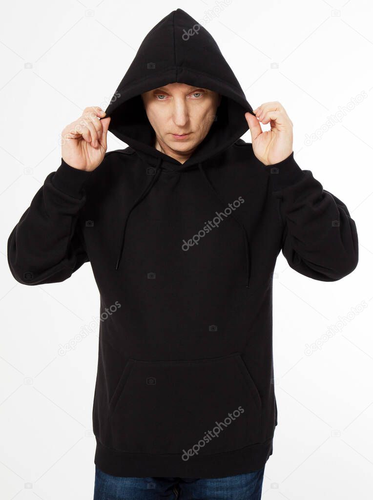 middle-aged man in a black hooded sweatshirt looks down - front view, mock up