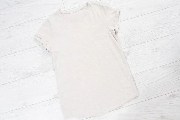 Clothes background top view, accessories summer concept t-shirt mock up on wooden floor, fashion shirt empty for logo, empty tshirt mockup background