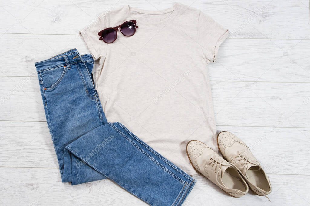 Clothes background top view, empty shirt fir your logo copy space mock up, t-shirt mockup isolated on wooden floor, summer vacation concept, male and female t shirt