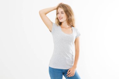 Young blonde woman with fit slim body in blank template t shirt and jeans isolated on white background. Skin and hair care. Copy space and mock up