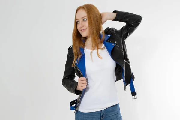 Woman in white t shirt and black leather jacket isolated on white background. Red hair girl in fashion clothes front view. Blank template summer t-shirt. Copy space