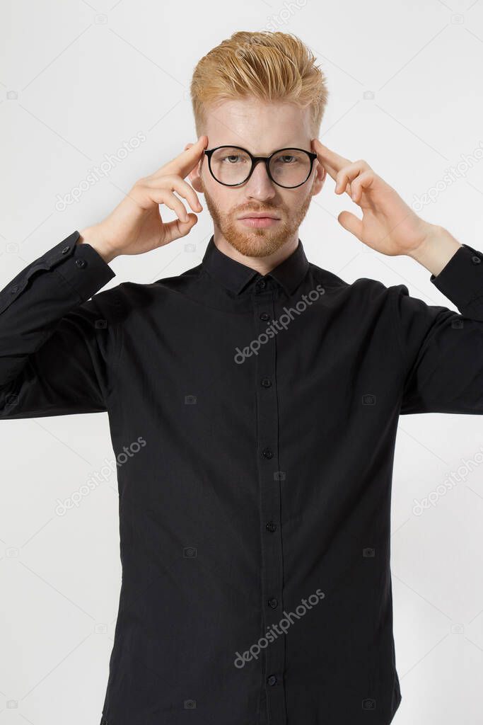 Young man in thinking process. Close up redheaded guy with red beard in black shirt, glasses focus on creating startup idea isolated on gray background. Intellect mind and brain power. Mental health.