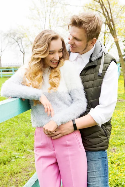 White couple hugging close-up portrait outdoor vertical image