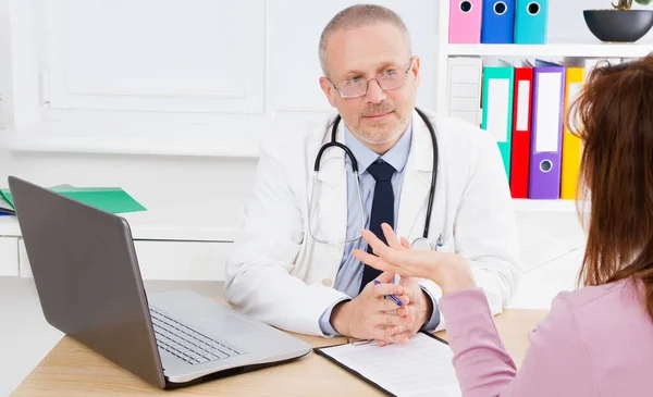 doctor carefully listens to the patient\'s complaints in medical office