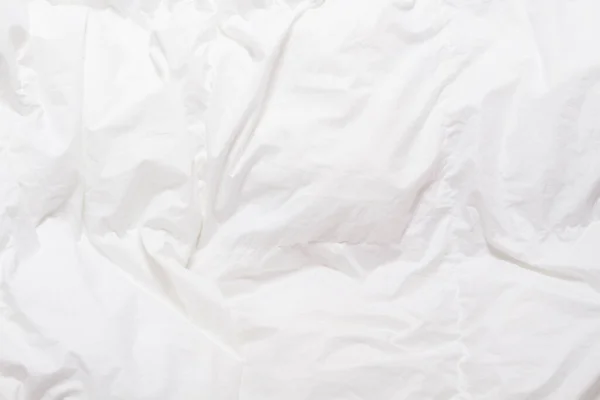 Top view of bedding sheets crease, white blanket texture. Close up of bedding sheets with copy-space