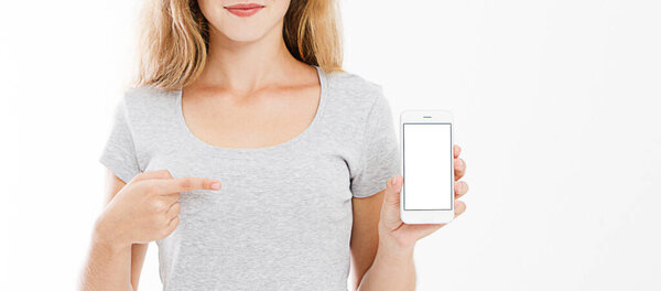 cropped portrait of smiling sexy woman in t shirt hold cellphone, blank screen mobilephone pointing isolated on white background, copy space.