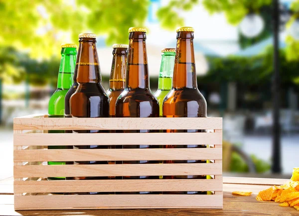 beer bottles on wooden table with blurred restaurant on background,coloured bottle, food and drink concept,selective focus,copy space