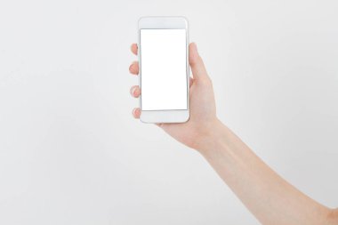 El ele tutuşan beyaz telefon içerideki beyaz kırpma yolunda izole edilmiş. Üst görünüm. Model. Boşluğu kopyala. Boşluk..
