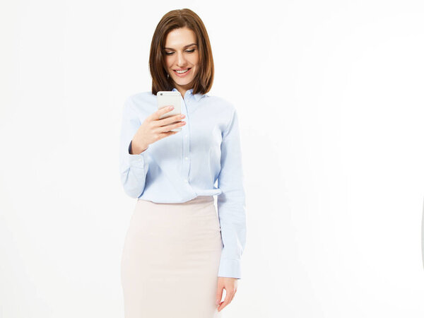 Modern smiling woman looks at something interesting in a mobile phone isolated, girl holding phone