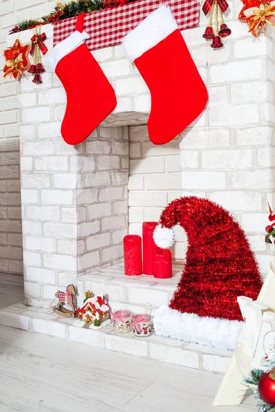 Decorative fireplace decorated with garlands and New Year\'s decor