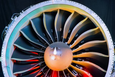 GTF type new generation fuel-efficient aircraft engine close up shot of fan blades inspection with red lights.
