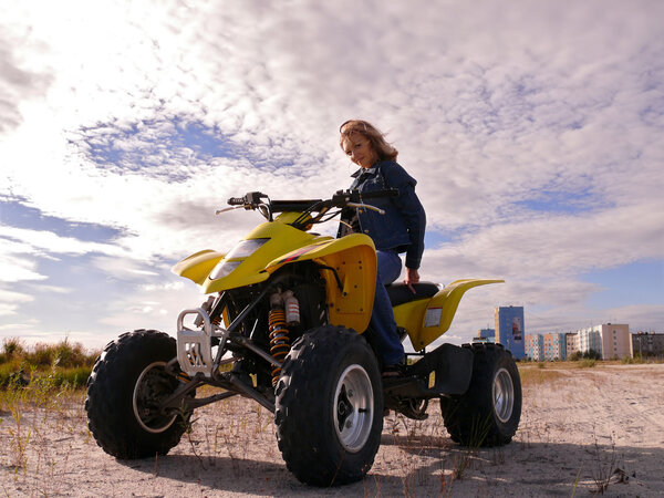 Beautiful blonde on sport quadrocycle. Sidebar.