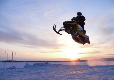 Vadim Vasuhin in jump with springboard on snowmobile during snow cross-country race April 06, 2008 in Nadym, Russia. clipart