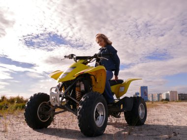 Beautiful blonde on sport quadrocycle. Sidebar. clipart