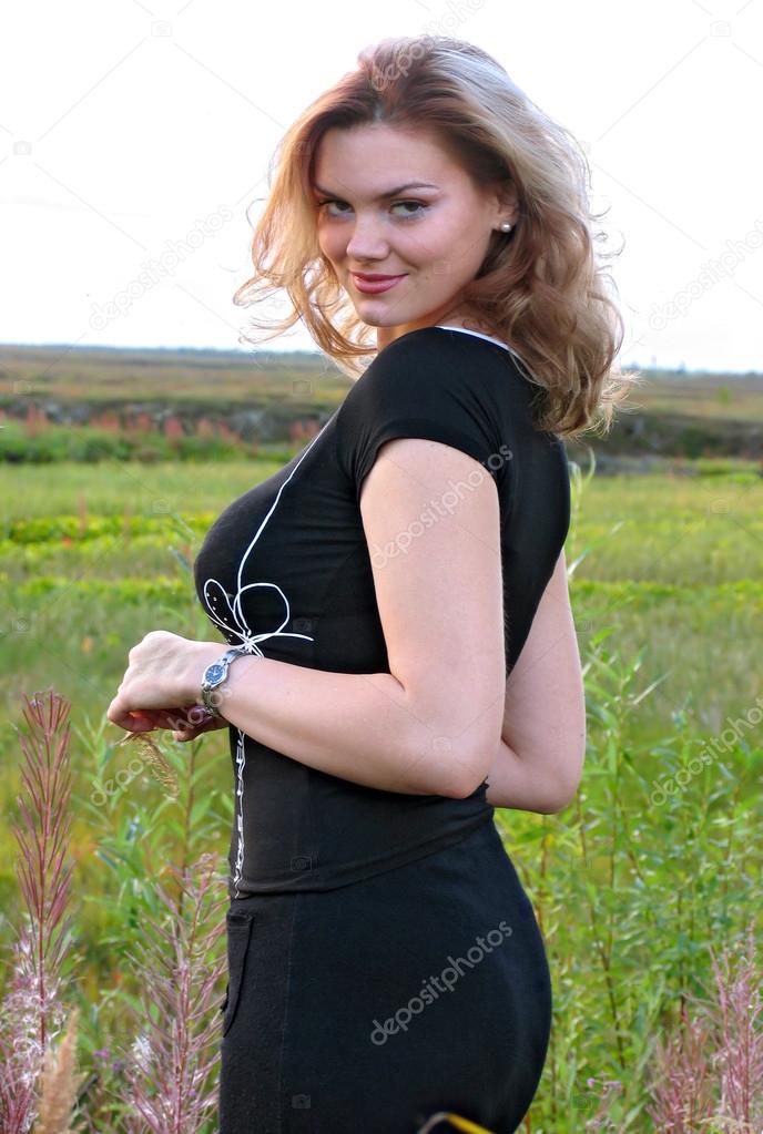 Beautiful girl with big breasts closeup on nature background.