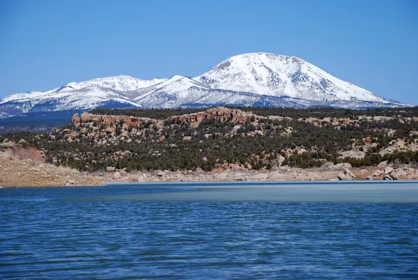 Abajo Mountains and winter lake in Utah Stock Photo