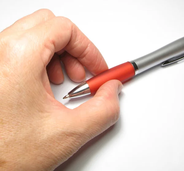 Women's arm with a ballpoint pen. — Stock Photo, Image