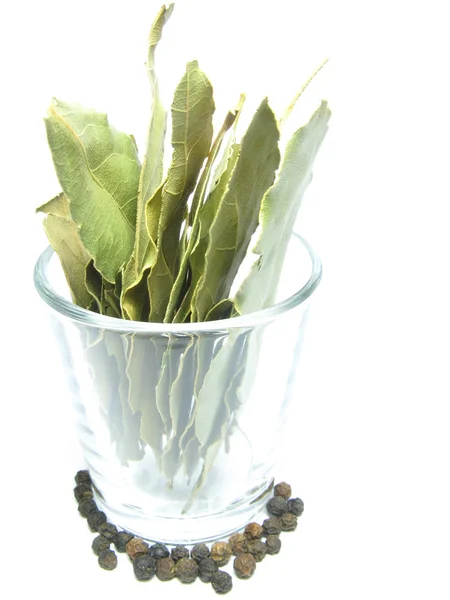 Black pepper and bay leaf in a glass — Stock Photo, Image