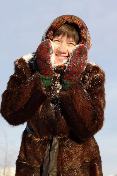 Cheerful woman in a fur coat and a scarf in winter — Stock Photo, Image