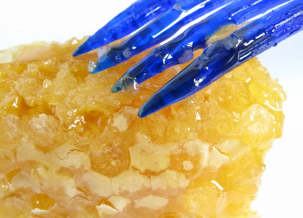 Honey on a plastic plug — Stock Photo, Image