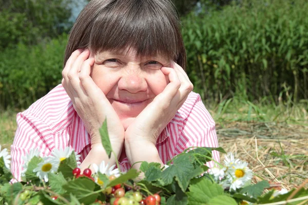 Middle-aged woman in a garden — Stock Photo, Image