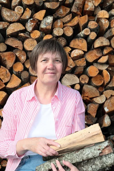 Woman with firewood — Stock Photo, Image