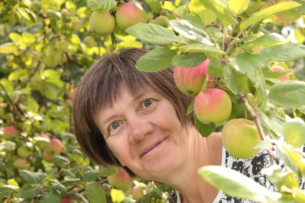 Middle-aged woman in the garden — Stock Photo, Image