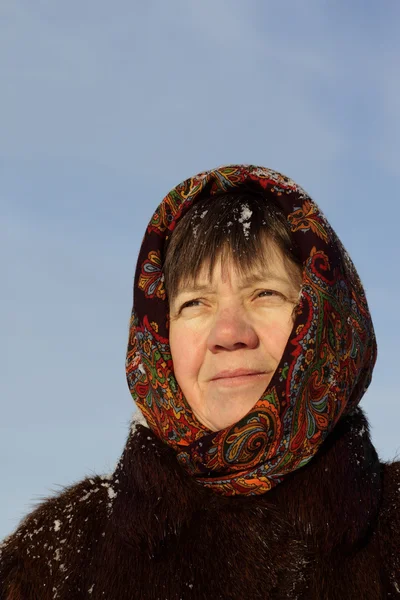 Cheerful woman in a fur coat and a scarf in winter — Stock Photo, Image