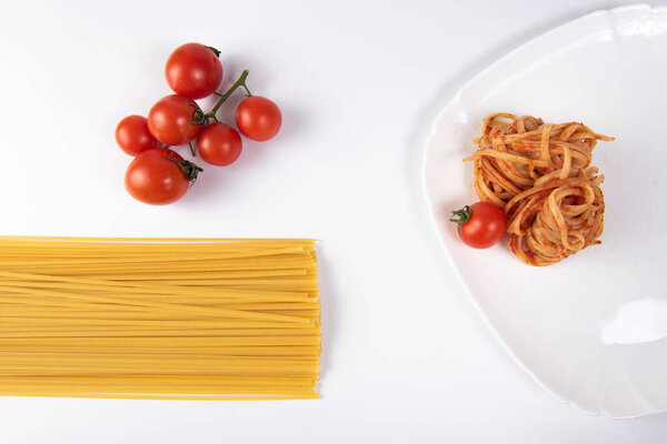 pasta with tomato sauce and basil on white dish.